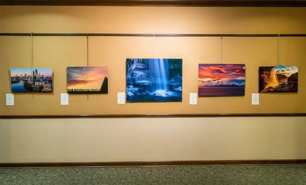 Large format photography exhibit in Sun City Texas featuring Austin 2026 skyline metal prints and Cucumber Falls acrylic wall art.
