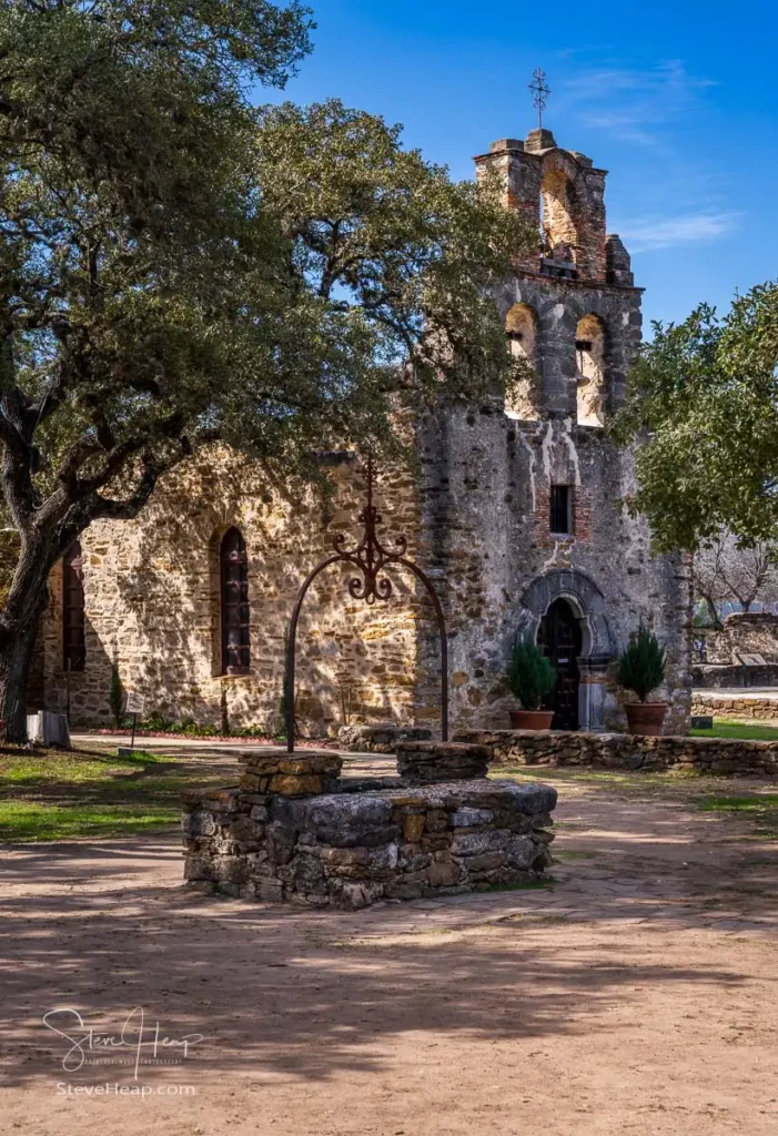 Espada mission church is a historic landmark near San Antonio, Texas, showcasing its weathered facade under a clear sky.