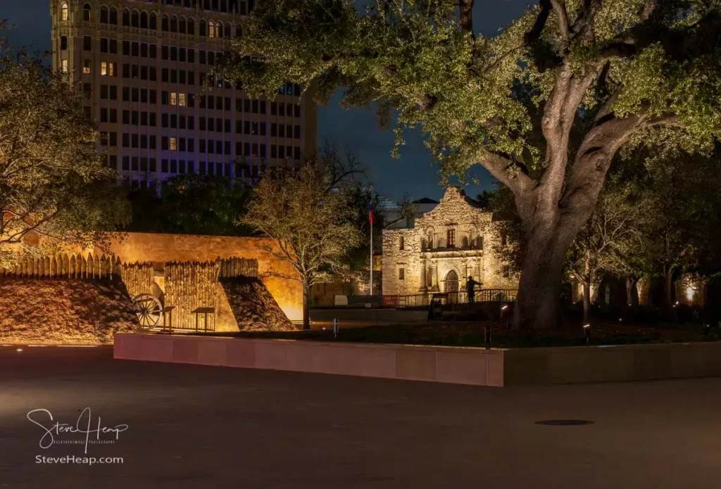 Illuminated Alamo Mission in San Antonio glows in the dark before sunrise revealing its iconic facade and historical charm.