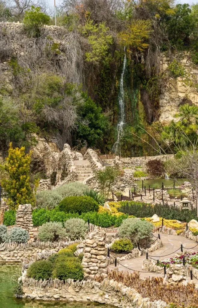 Close-up texture study of water cascading down the rocky waterfall at the San Antonio Japanese Tea Garden
