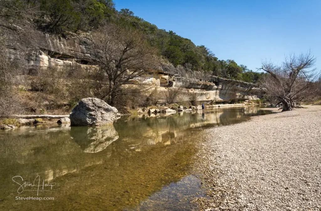 Landscape view of the rocky banks and flowing water at Guadalupe River State Park in the Texas Hill Country