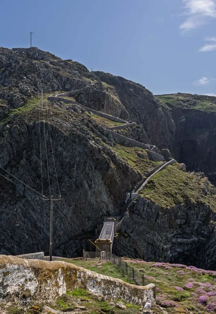 Steep, zigzagging stone cliff path and bridge leading to South Stack Lighthouse