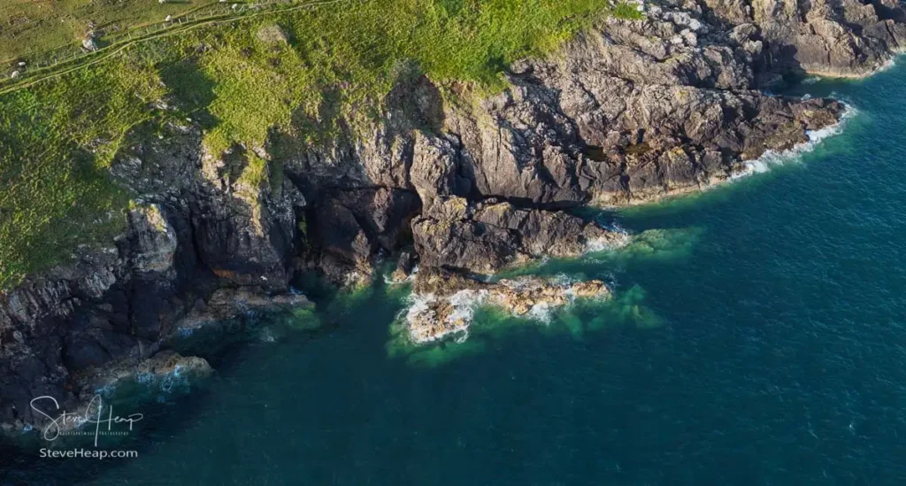 High-angle aerial shot looking straight down at the rugged cliff edge and whitewashed foam of the sea. Prints available in my online store.