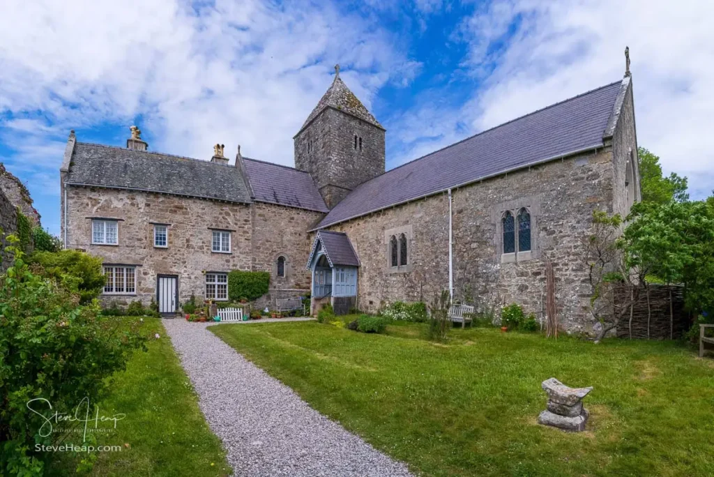 Historic stone church, square tower, and grounds at Penmon Priory on eastern Anglesey
